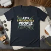 I Fix Knotty People Massage Therapist quote on a dark t-shirt with decorative knot and leaf graphics