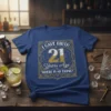 T-shirt with gold and white text saying "I Gave Birth 21 Years Ago Where Is My Drink?" in a vintage