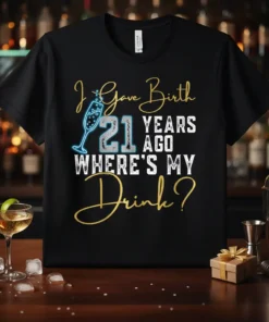 Black t-shirt with "I Gave Birth 21 Years Ago WHERE'S MY Drink?" text, featuring a champagne glass graphic and gold