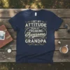T-shirt with text "I Get My Attitude From My Freaking Awesome Grandpa" in vintage-style typography, navy blue shirt