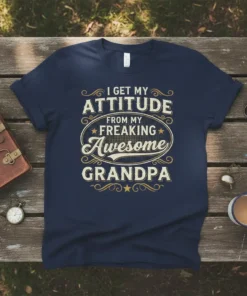 T-shirt with text "I Get My Attitude From My Freaking Awesome Grandpa" in vintage-style typography, navy blue shirt