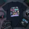I Go To School In My Pajamas text design with colorful letters, globe, and alarm clock graphic