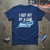 Dark blue t-shirt with white text "I GOT HIT BY A CAR" and a neon blue outline of a car