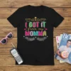 I Got It From My Momma text design with colorful lettering and decorative elements, on a black t-shirt
