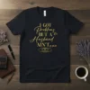 Black t-shirt with gold glitter text "I GOT Problems BUT A Husband AIN'T one" and wedding rings graphic