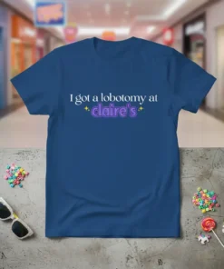 Blue t-shirt with white and purple text saying "I got a lobotomy at claire's" and sparkling stars