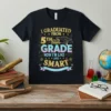 T-shirt design with text "I GRADUATED FROM 5TH GRADE NOW I'M LIKE AND SMART" and a graduation cap over a