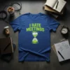 Blue t-shirt with "I HATE MEETINGS" in green distressed font and a cracked hourglass graphic below