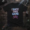 Black t-shirt with "I HATE THIS GAME" text in glitchy font and a cracked video game controller graphic