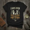 Black t-shirt with "I Have Been Social Distncing For Years" text and Bigfoot graphic amidst pine trees and mountains