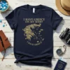Navy blue t-shirt with gold text "I HAVE GREECE ON MY SHIRT" and a detailed gold map of Greece below