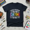 I Have Neither The Time Nor The Crayons To Explain This To You quote on a black t-shirt, featuring colorful