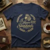 Navy t-shirt with gold glitter "I Have Standards" text and a regal poodle graphic, laurel wreath, and "Standard Poodle Co."
