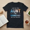 I Have Two Titles Aunt And Godmother And I Rock Them Both quote on a dark t-shirt, featuring bold, colorful