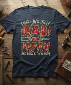 I Have Two Titles Dad And Papaw And I Rock Them Both quote on a navy t-shirt with plaid and