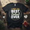 Black t-shirt with "I Have The Best Husband Ever" text in white and gold, featuring a circular design and stars