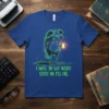 I Have To Say Weird Stuff Or I'll Die quote on a blue t-shirt featuring a neon-outlined frog holding coffee