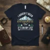 T-shirt with the quote "I Haven't Been Everywhere But It's On My List" featuring mountains and trees graphic