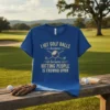 Blue t-shirt with gold text that reads "I HIT GOLF BALLS because HITTING PEOPLE IS FROWND UPON" and graphics of