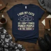I Hug My Cats So I Don't Punch People In The Throat quote on a navy t-shirt with cat graphics