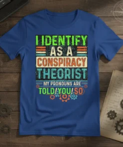 I Identify As A Conspiracy Theorist quote tee with bold typography and gear graphics. Pronouns are Told/You/So