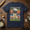 Dachshund wearing chef hat holding cupcakes with text "I Just Baked You Some Shut The Fucupcakes" on a navy t-shirt