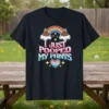 Black t-shirt with "I Just Pooped My Pants" text, featuring a rainbow, clouds, and poop emojis above a heart graphic
