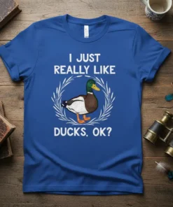 I JUST REALLY LIKE DUCKS, OK? text with a mallard duck graphic, white wreath, on a blue t-shirt