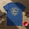 I just want all the dogs quote with paw prints and bone graphic on a blue t-shirt