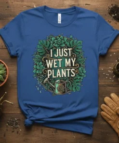T-shirt with the text "I Just Wet My Plants" surrounded by lush green leaves and a watering can graphic