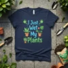 T-shirt with "I Just Wet My Plants" text and cute potted plants graphics, featuring watering cans and green leaves