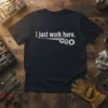 Black t-shirt with white text "I just work here." and gear graphic, suitable for mechanics and technicians
