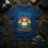 T-shirt with "I Keep All My Dad Jokes In A Dad-A-Base" text and vintage floppy disk graphic, retro sunset background
