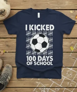 T-shirt featuring "I Kicked 100 Days of School" text with a soccer ball graphic and tally marks