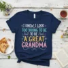 T-shirt with text "I Know I Look Too Young To Be A Great Grandma" in colorful, playful font with floral