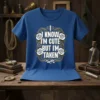 Blue t-shirt with "I Know I'm Cute But I'm Taken" text and white roses graphic, featuring a heart and ribbon
