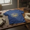 Blue t-shirt with gold text "I Know Things" above an open book graphic, compass, and magnifying glass