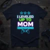 I Leveled Up To Mom text design with neon glow, stars, and a video game controller graphic