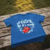Blue t-shirt with white text "I licked it so it's mine" and a red graphic of lips and tongue, surrounded