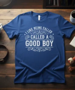 White text on a blue t-shirt reads "I LIKE BEING CALLED CALLED A GOOD BOY" in a decorative font, ideal