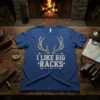 Blue t-shirt with "I Like Big Racks" text and deer antlers graphic, designed for hunters
