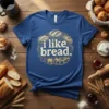 Blue t-shirt with "i like bread." text surrounded by illustrated loaves of bread in a circular design