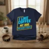 Navy blue t-shirt with text "I LIKE COFFEE MY DOG AND MAYBE 3 PEOPLE" in blue and yellow, perfect for