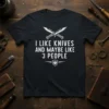 Black t-shirt with white text "I LIKE KNIVES AND MAYBE LIKE 3 PEOPLE" and crossed knives graphic