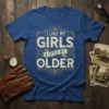 T-shirt with text "I Like My Girls A Little Bit Older" in distressed vintage font, navy blue shirt