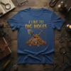 I Like To Dig Holes quote t-shirt with shovel, pickaxe, skull, and gold coins graphic