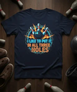 I Like To Put It In All Three Holes quote with bowling ball and pins graphic on a navy t-shirt