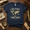 I Look At Maps And I Know Things quote on a navy blue t-shirt with a vintage world map graphic