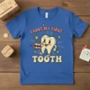 Retro graphic t-shirt design with pink text "I Lost My First Tooth" and a smiling cartoon tooth character