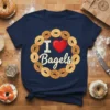 Navy blue t-shirt with "I Love Bagels" text and a heart, surrounded by a wreath of bagels